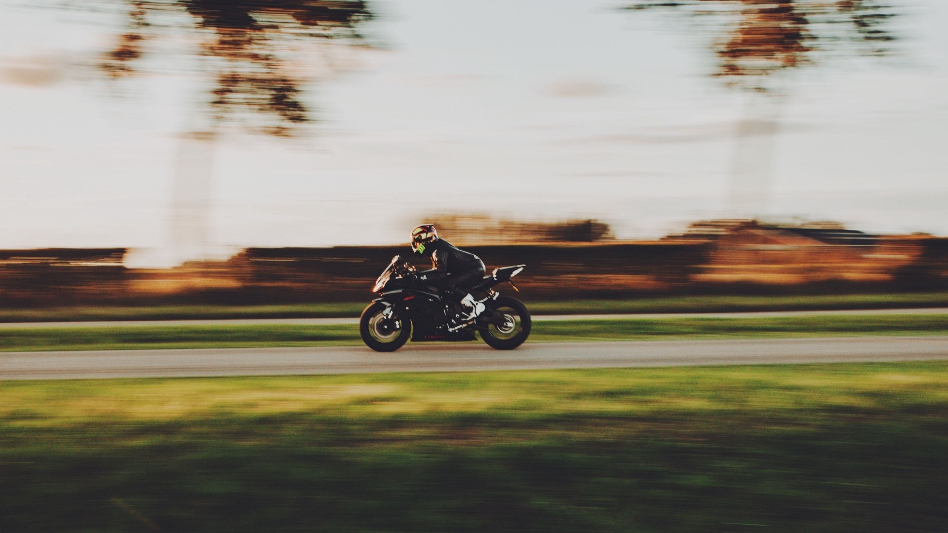 Motorcyclist riding a sportbike on a road HD Wallpaper