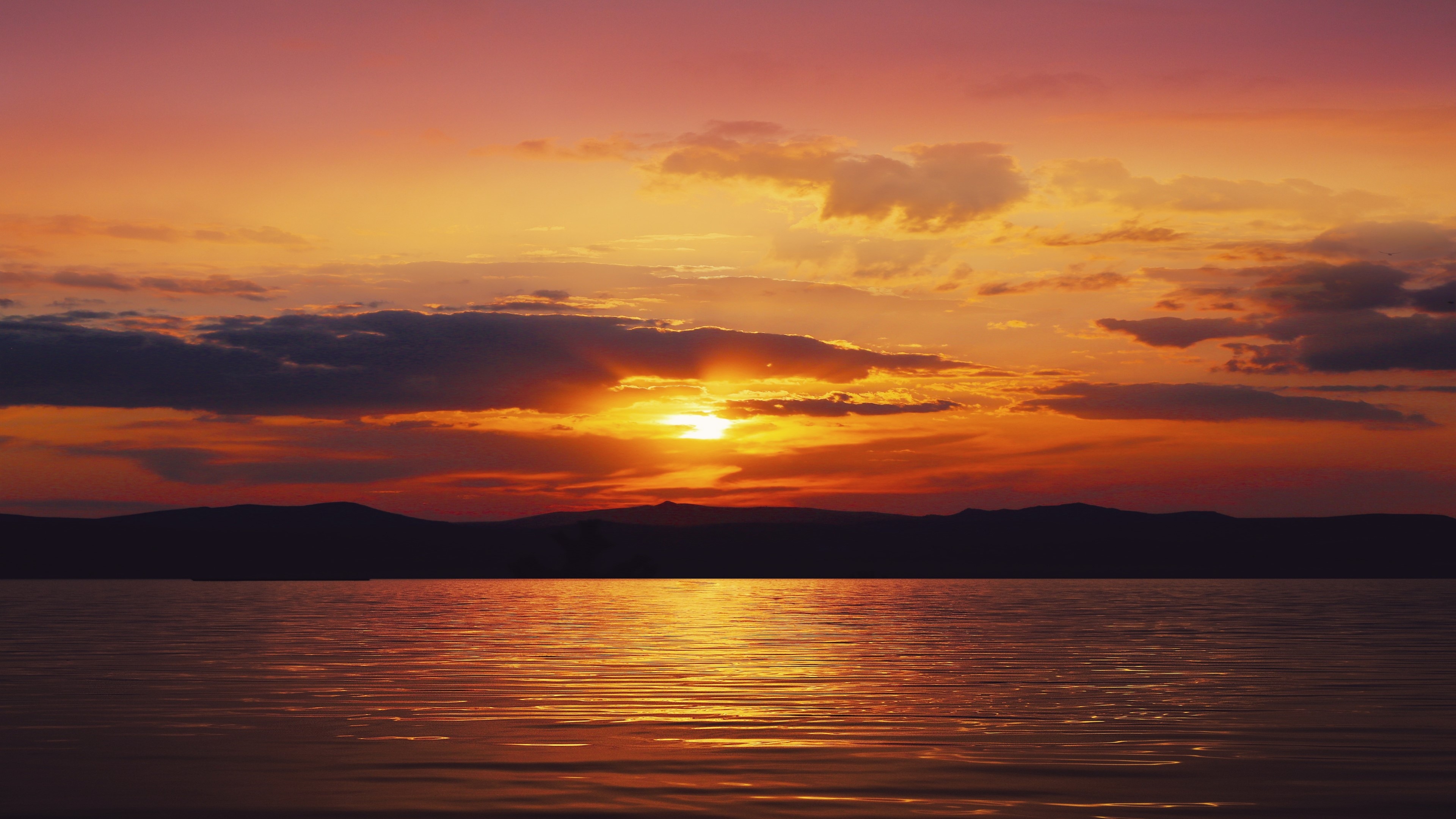 4K Sunset over Water with Mountains HD Wallpaper