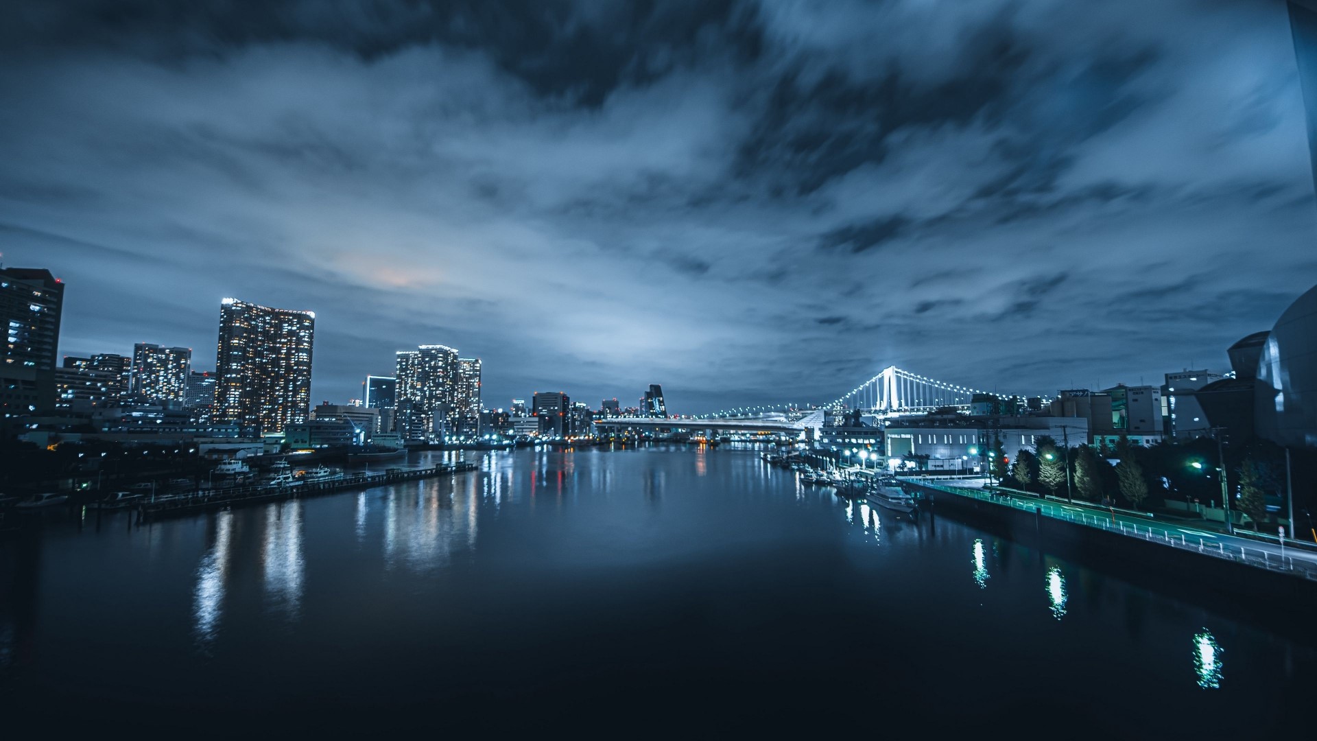 Night cityscape with illuminated bridge over water HD Wallpaper