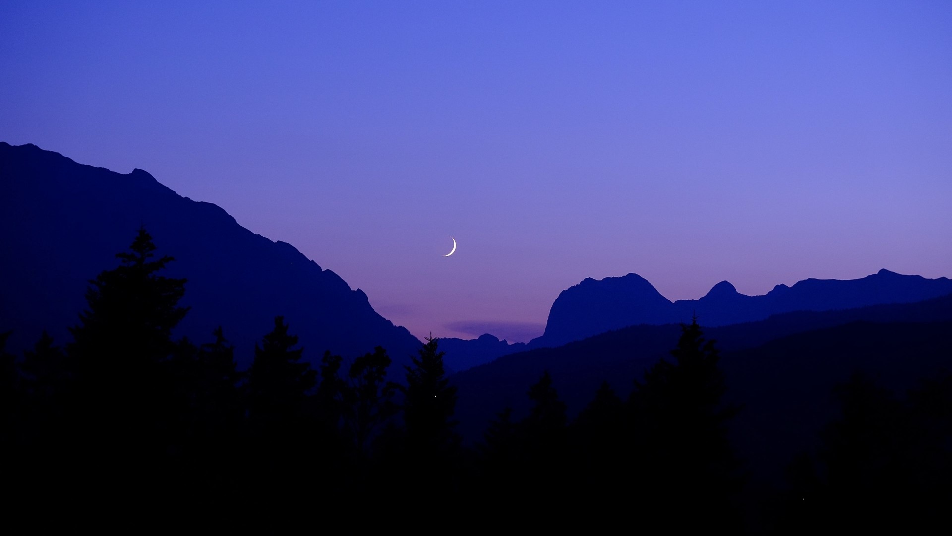 Crescent moon over silhouetted mountains and trees at dusk HD Wallpaper