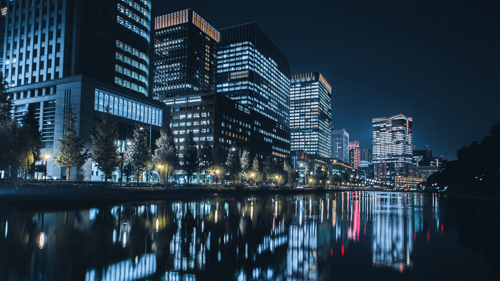 Night city skyline with reflections in water HD Wallpaper