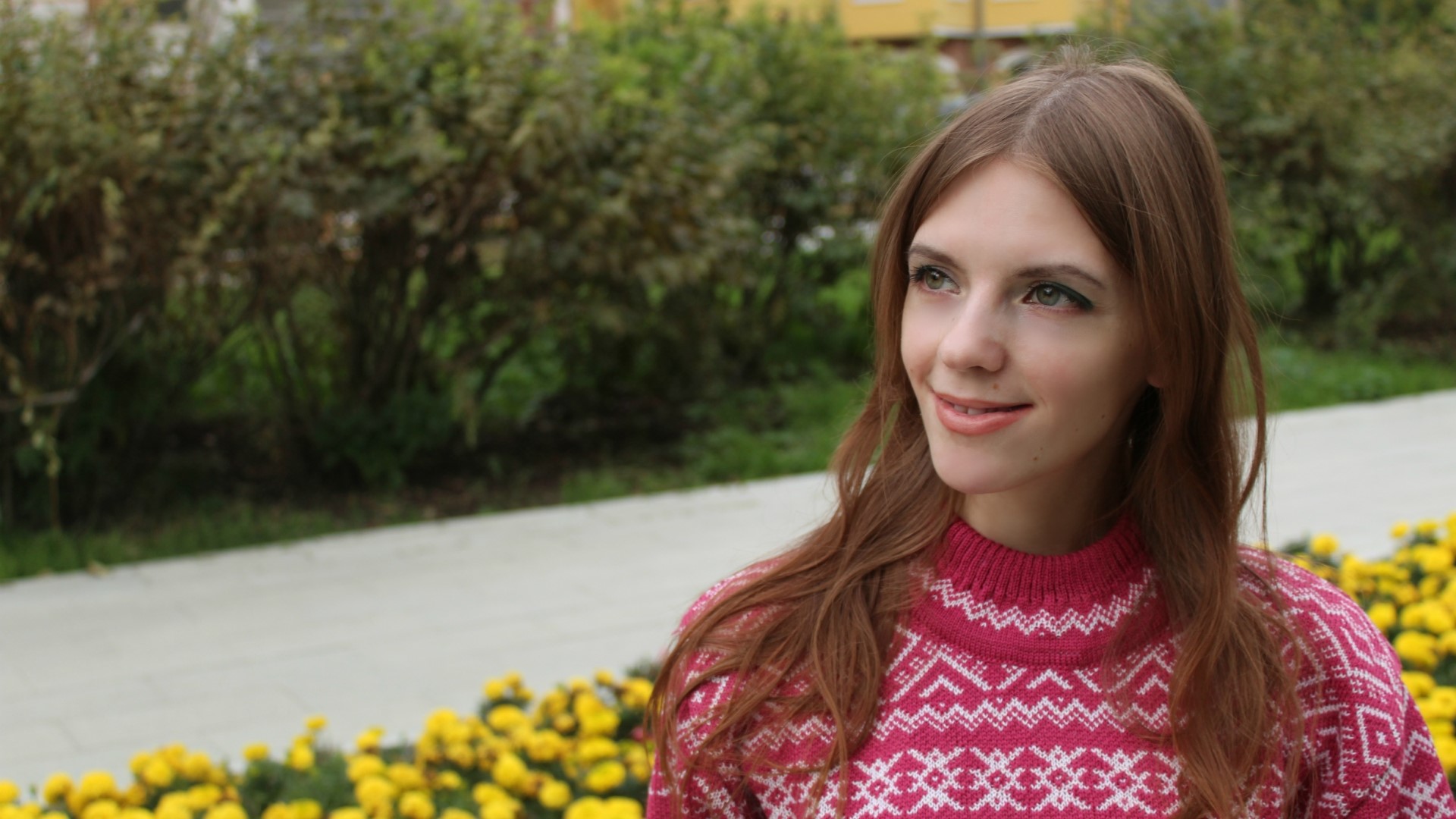 Cute girl in a patterned sweater outdoors HD Wallpaper