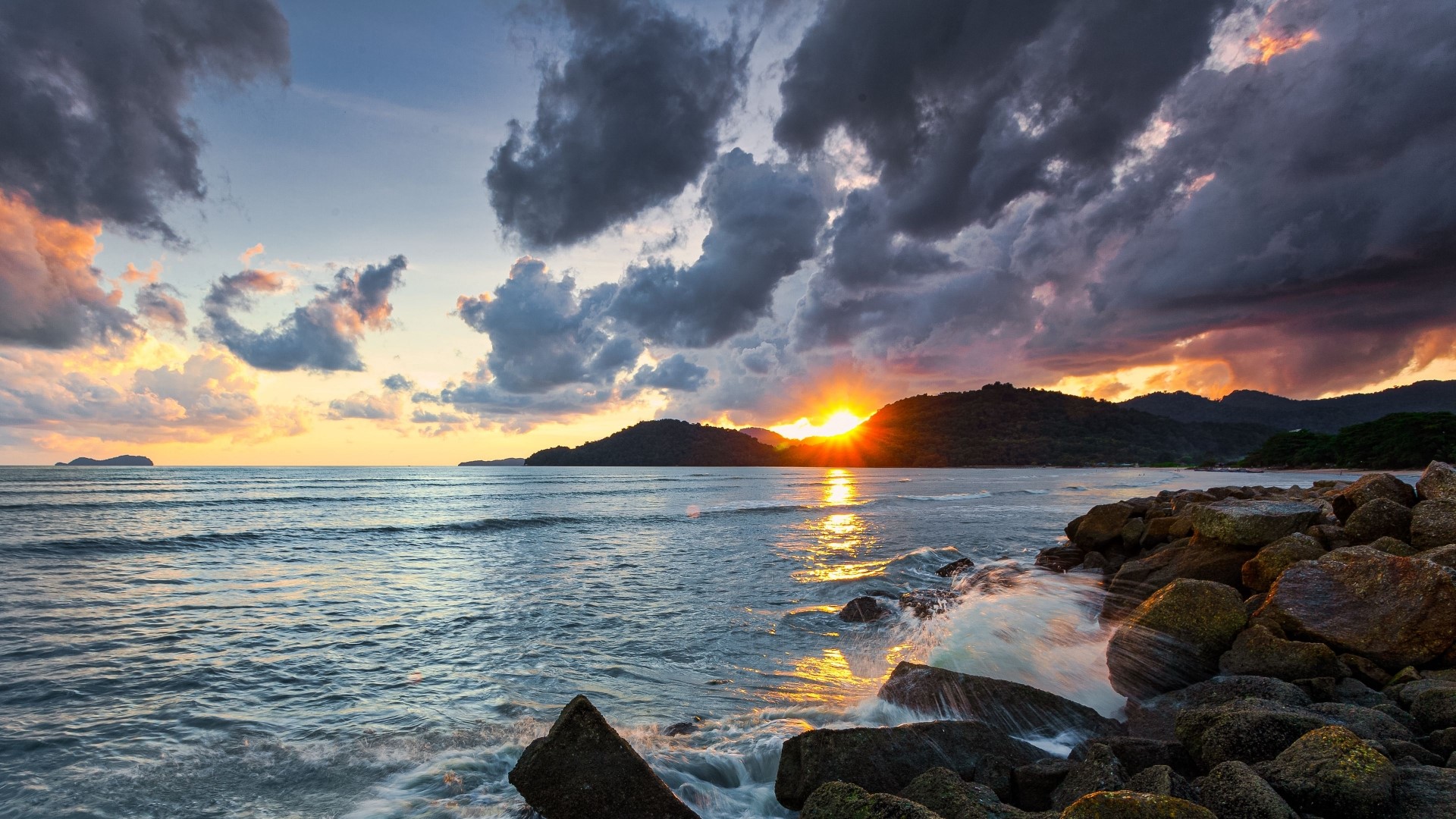 Sunset over the ocean with rocky shore HD Wallpaper