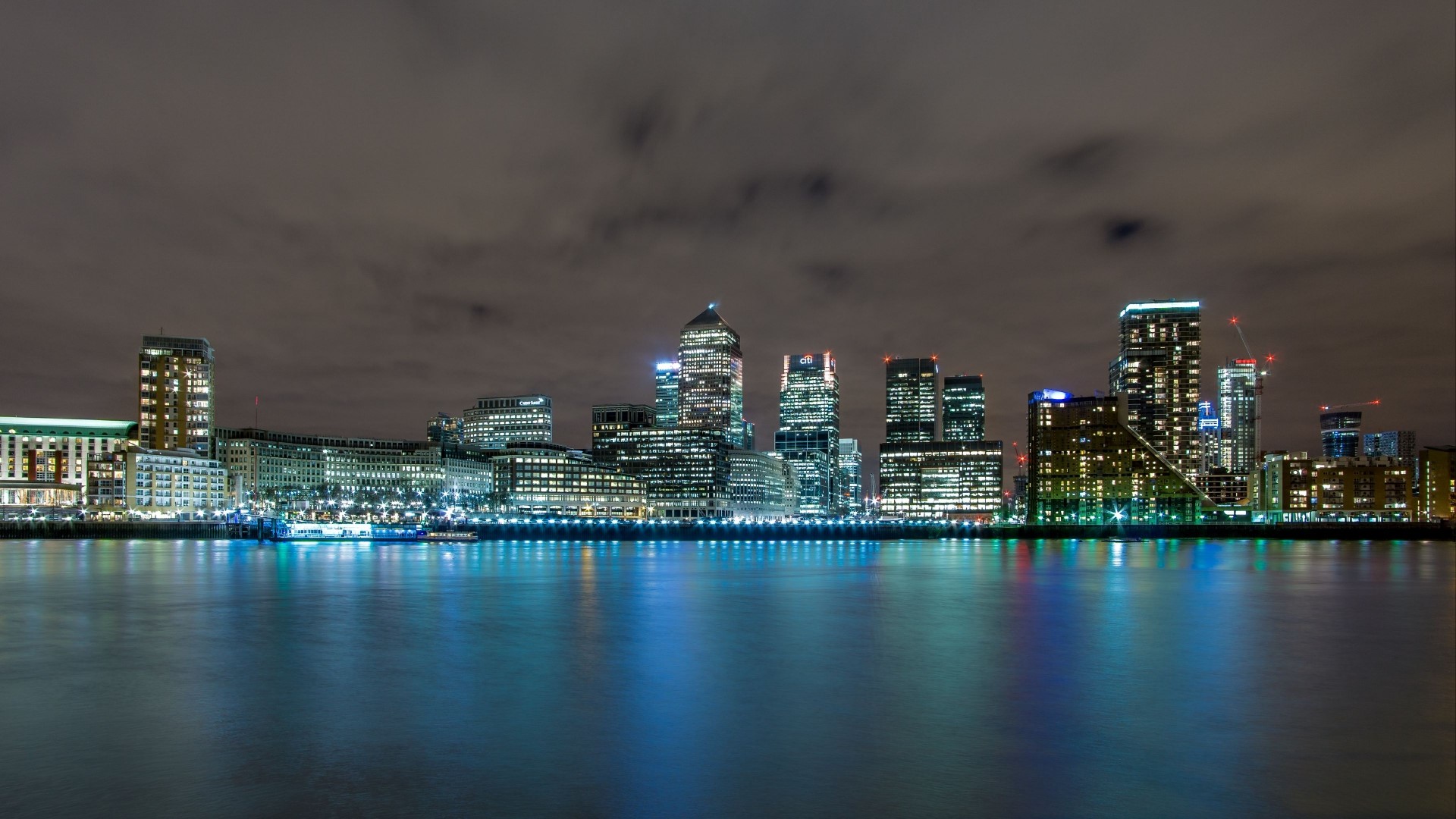 Night cityscape with illuminated skyscrapers and river HD Wallpaper