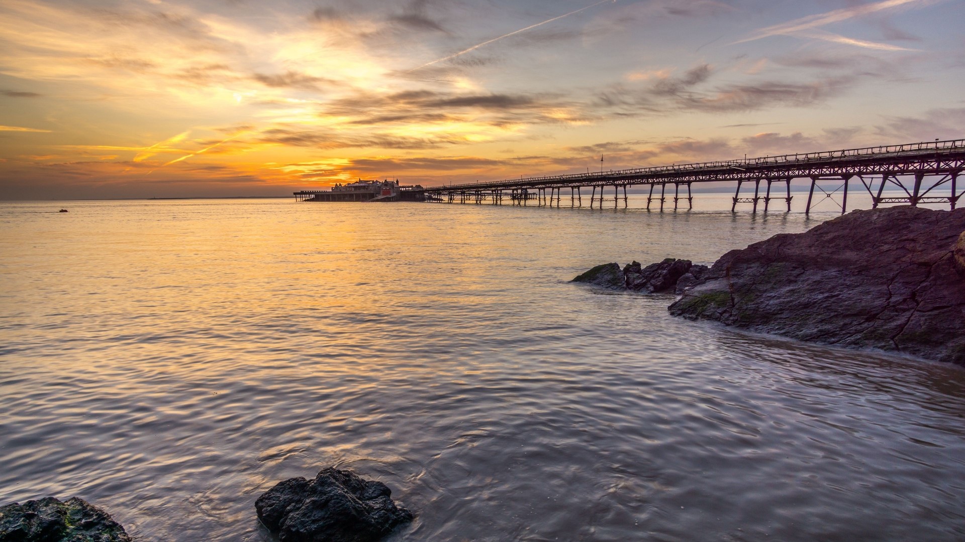 Pier over the ocean at sunset HD Wallpaper