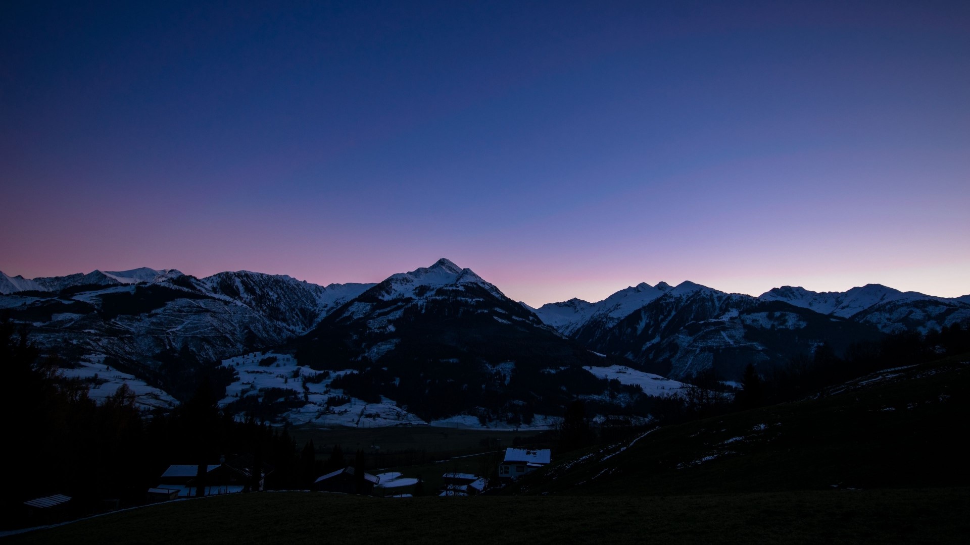 Snowy mountains at twilight with houses HD Wallpaper