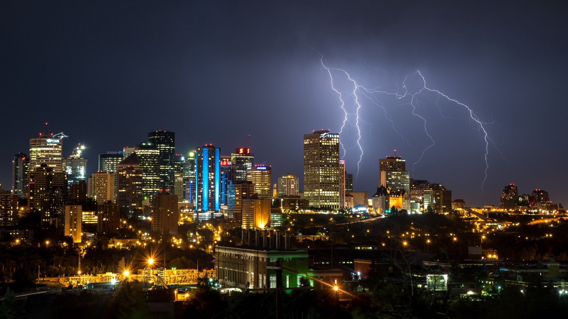 City skyline at night with lightning strikes HD Wallpaper