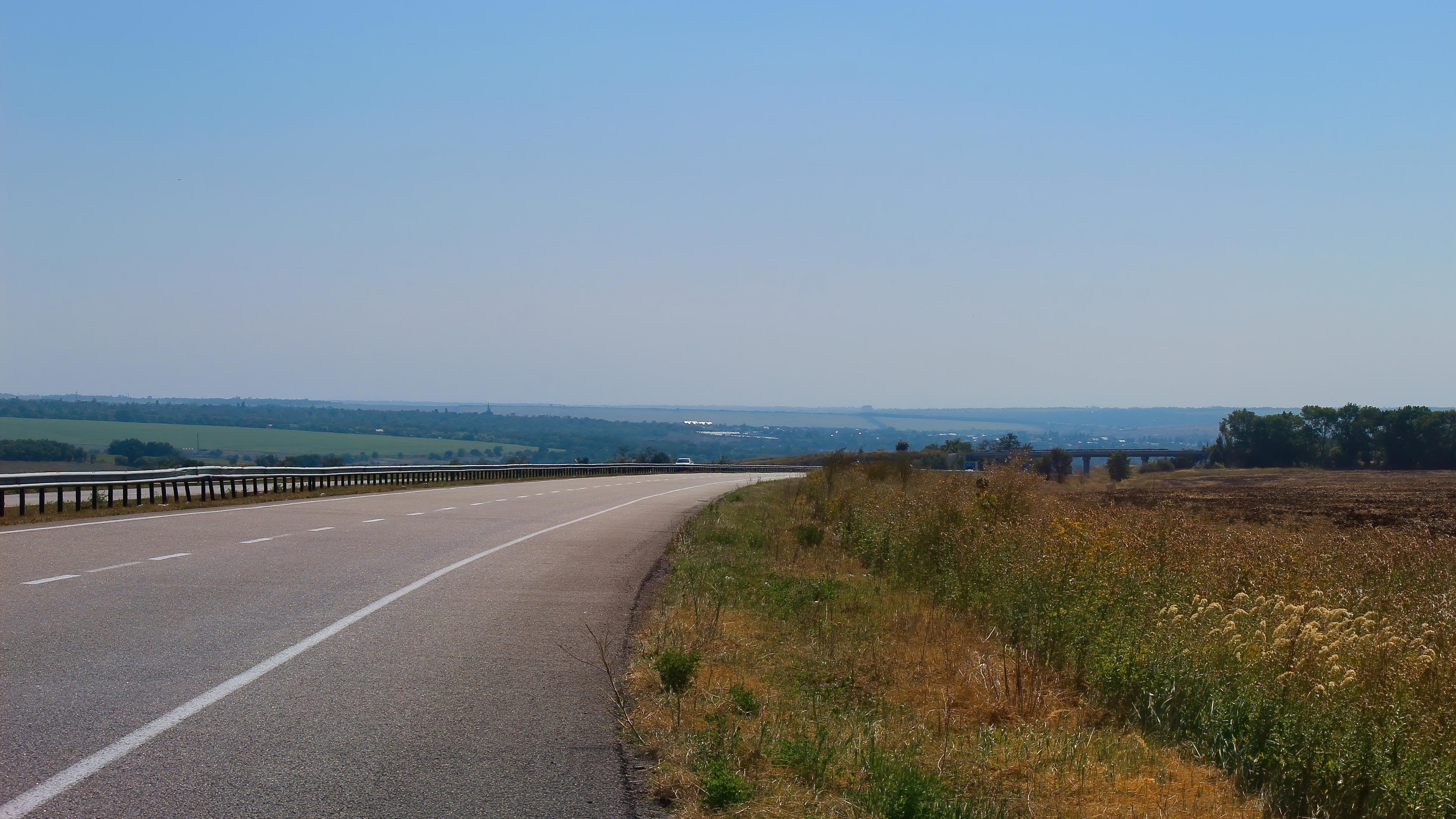 4K Road with Guardrail and Fields HD Wallpaper
