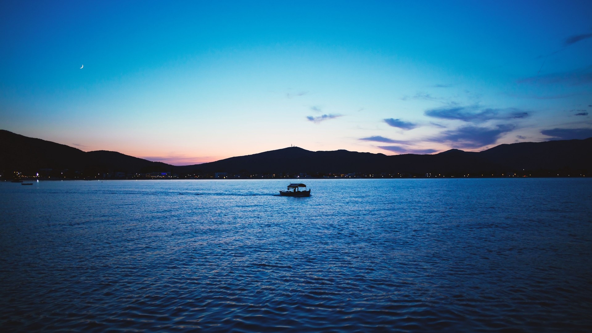 Boat on the water at dusk with mountains HD Wallpaper