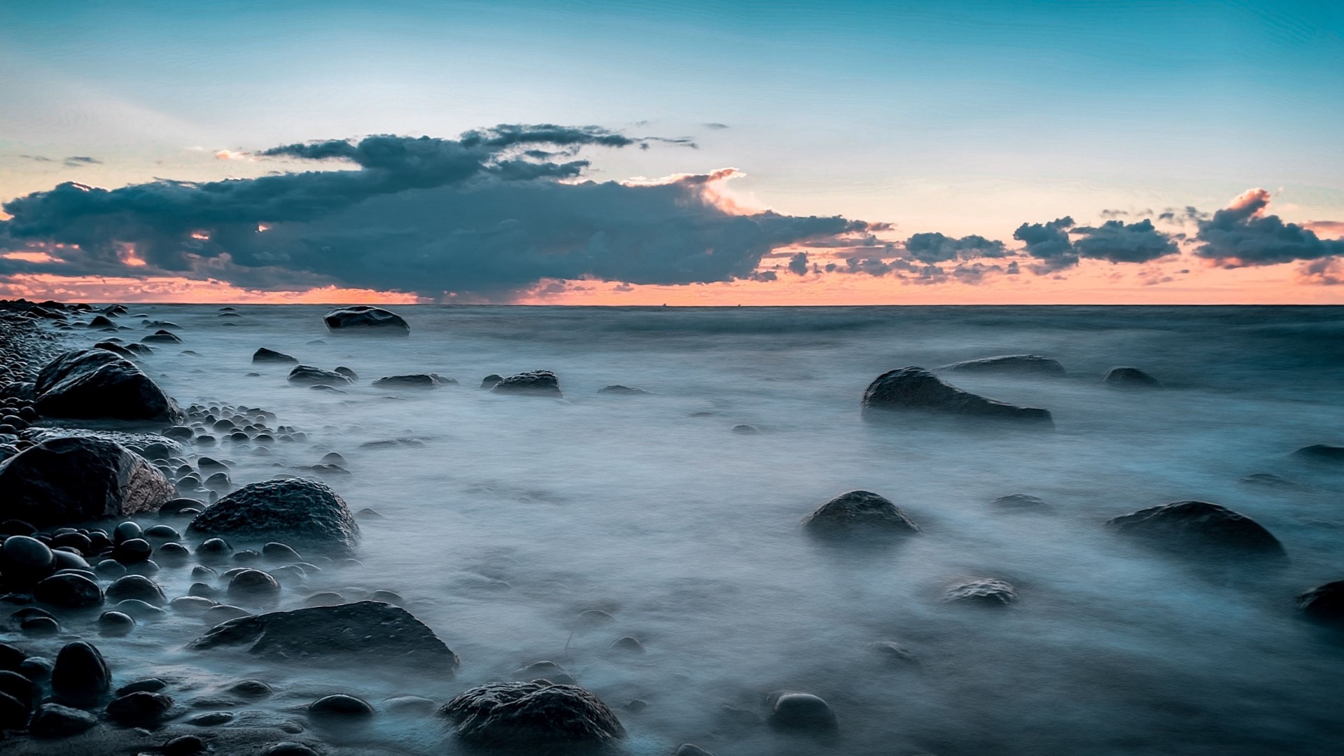 Rocky coast with misty ocean at sunset HD Wallpaper