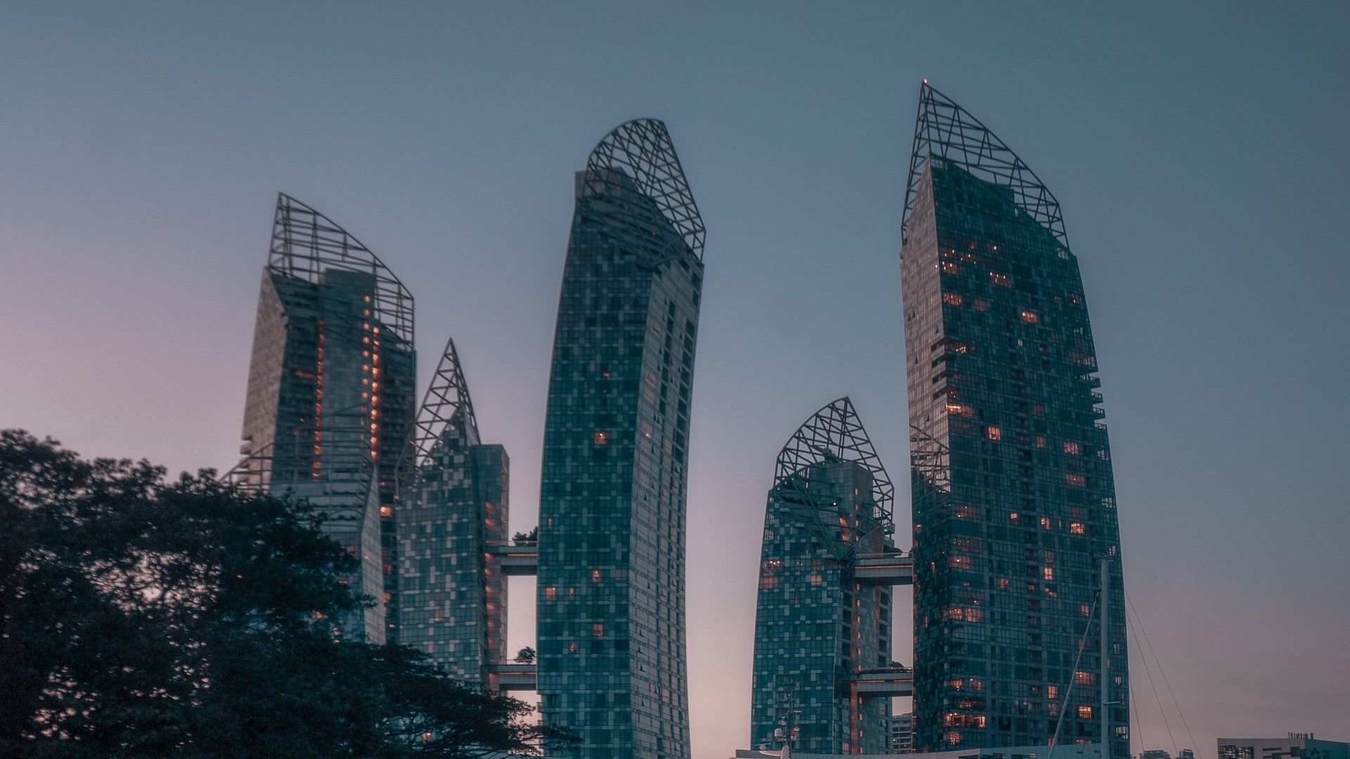 Skyscrapers at dusk with connecting bridges HD Wallpaper
