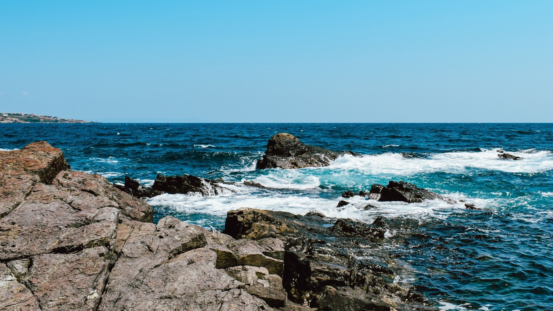 Rocky Coastline with Blue Ocean and Clear Sky HD Wallpaper