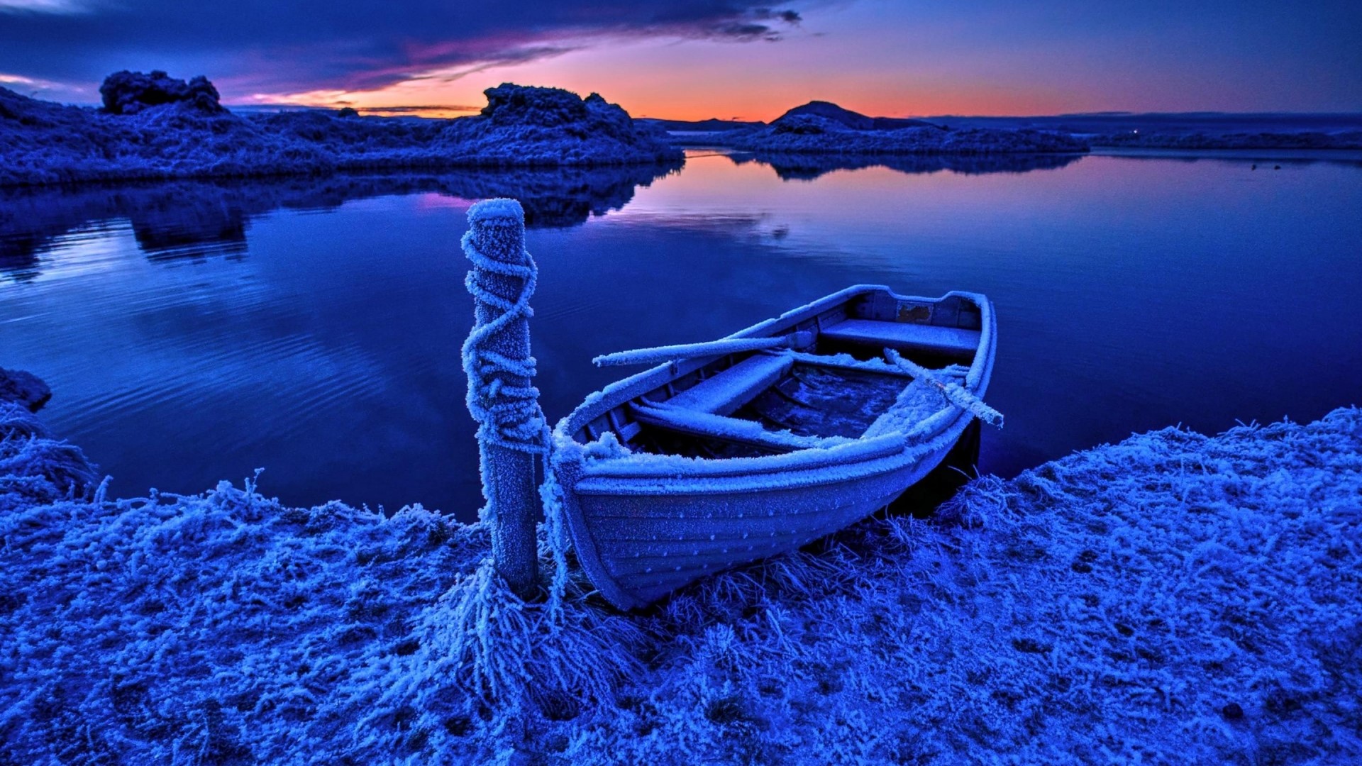 Frosty boat on a frozen lake at sunset HD Wallpaper