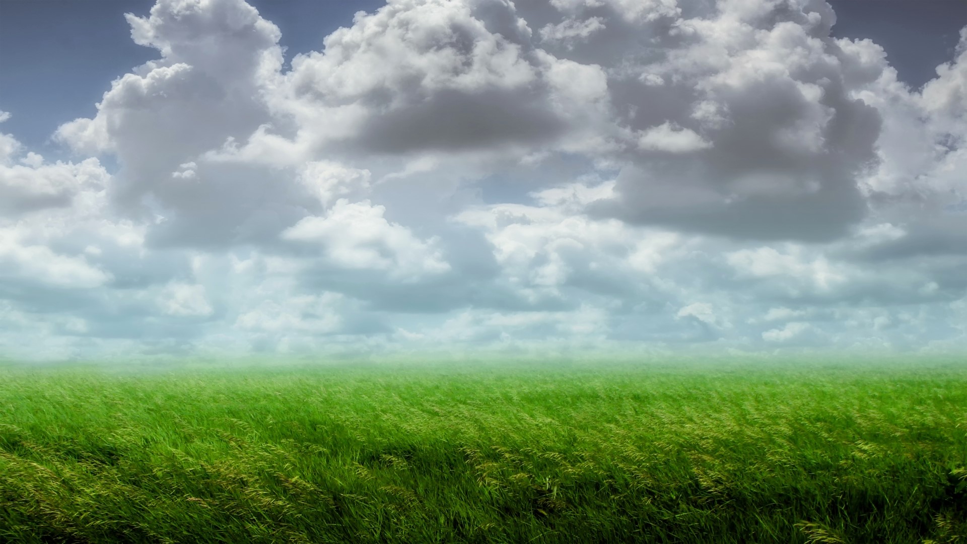 Clouds over a green field HD Wallpaper