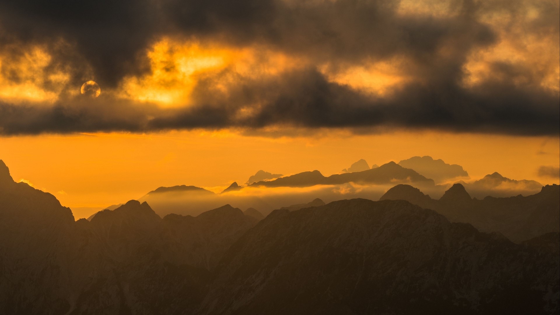 Sunset over misty mountain range HD Wallpaper