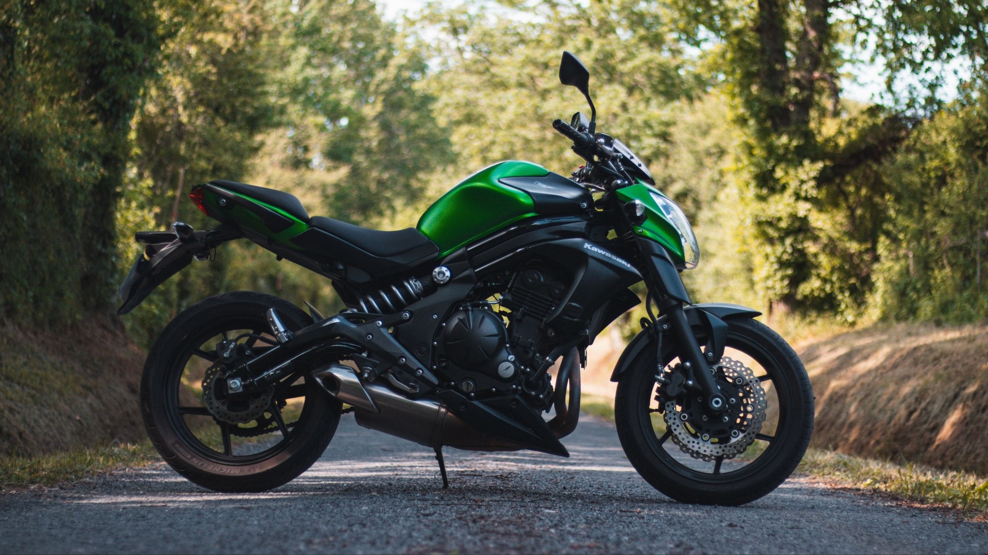 Green Kawasaki Er-6n motorcycle on a road HD Wallpaper