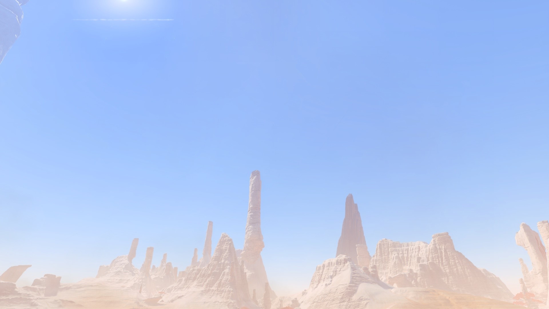 Desert rock formations under a bright sky HD Wallpaper
