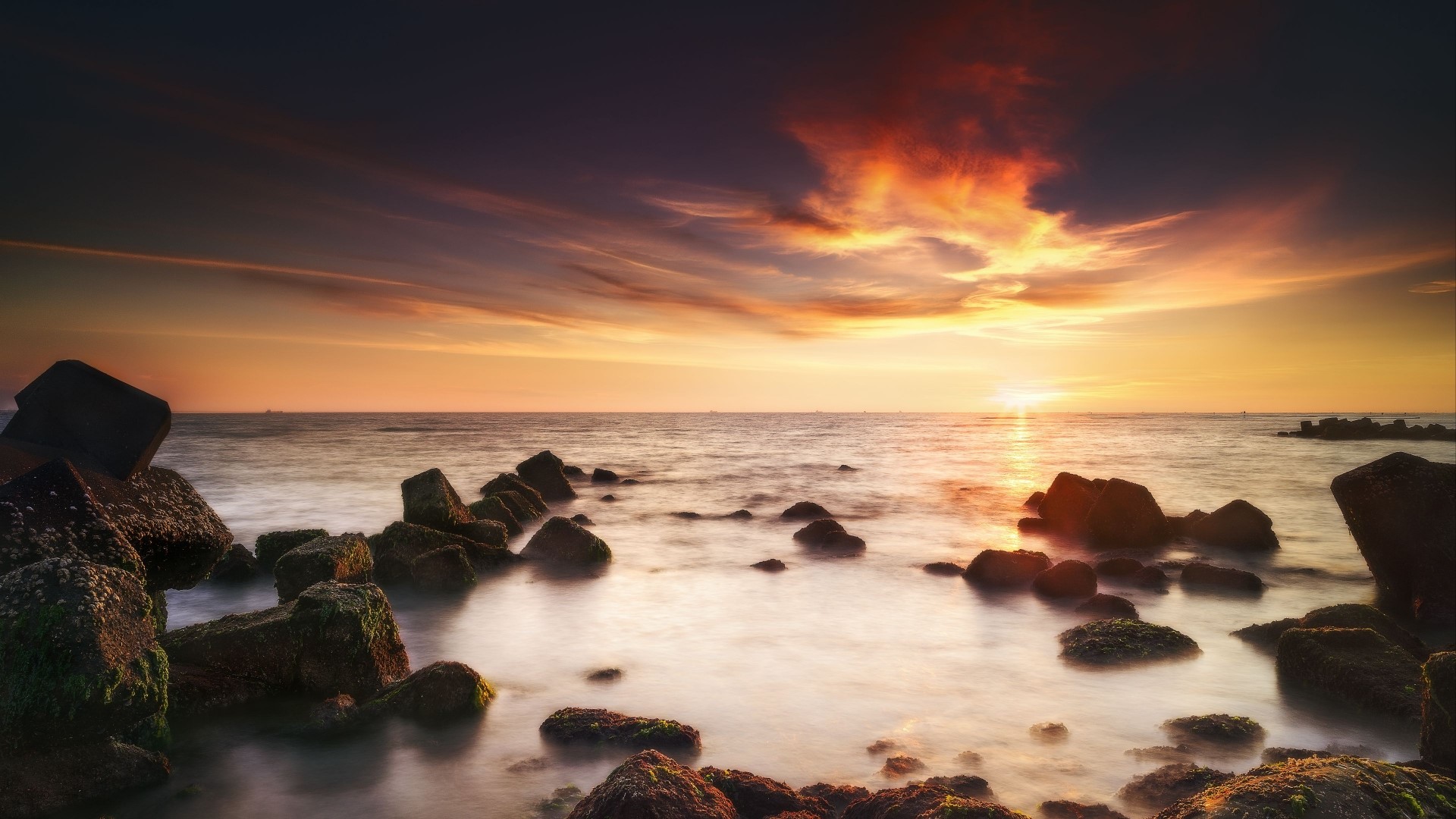 Sunset over the ocean with rocks HD Wallpaper