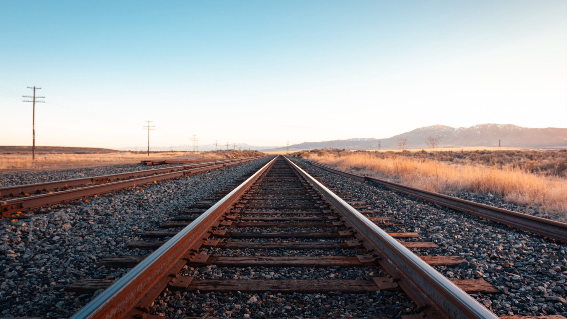 Railway tracks stretching into the distance HD Wallpaper
