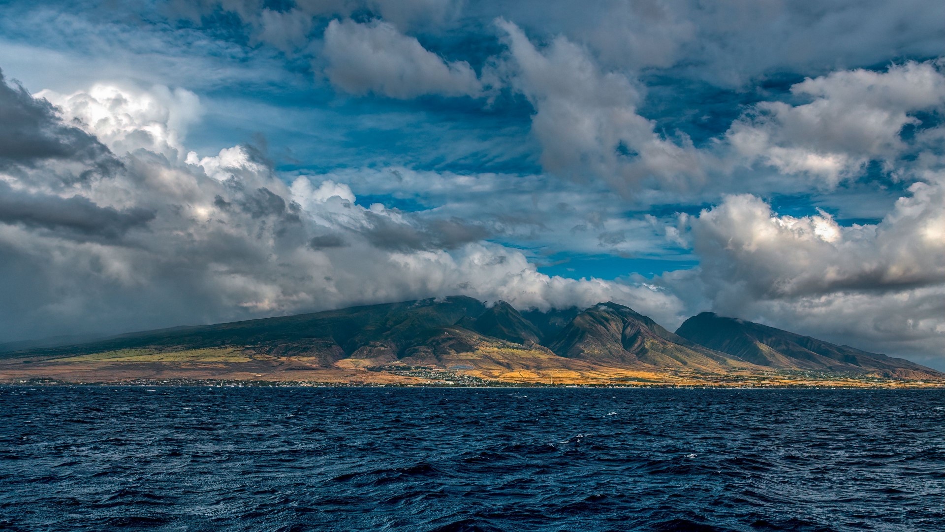 Mountains and ocean under cloudy sky HD Wallpaper