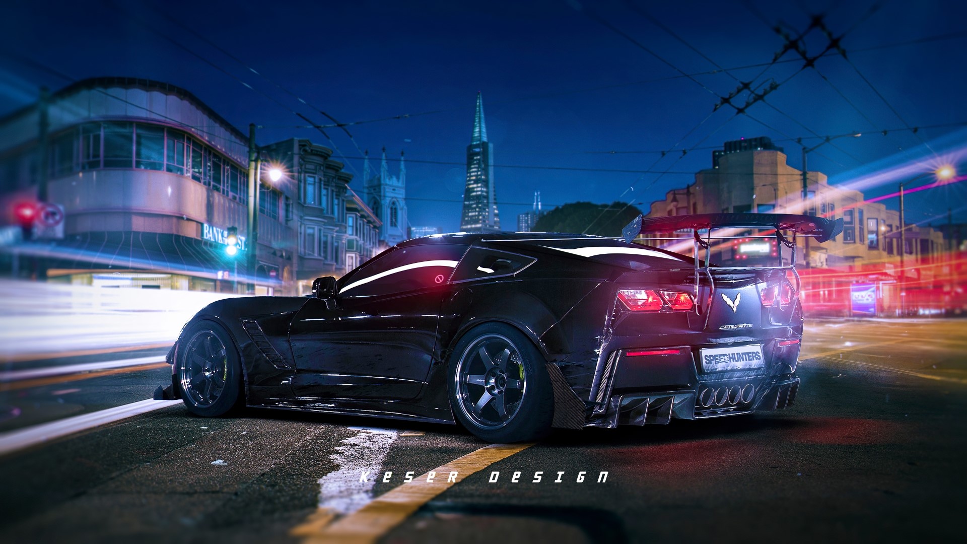 Black Corvette C7 with a large rear spoiler on a city street at night HD Wallpaper