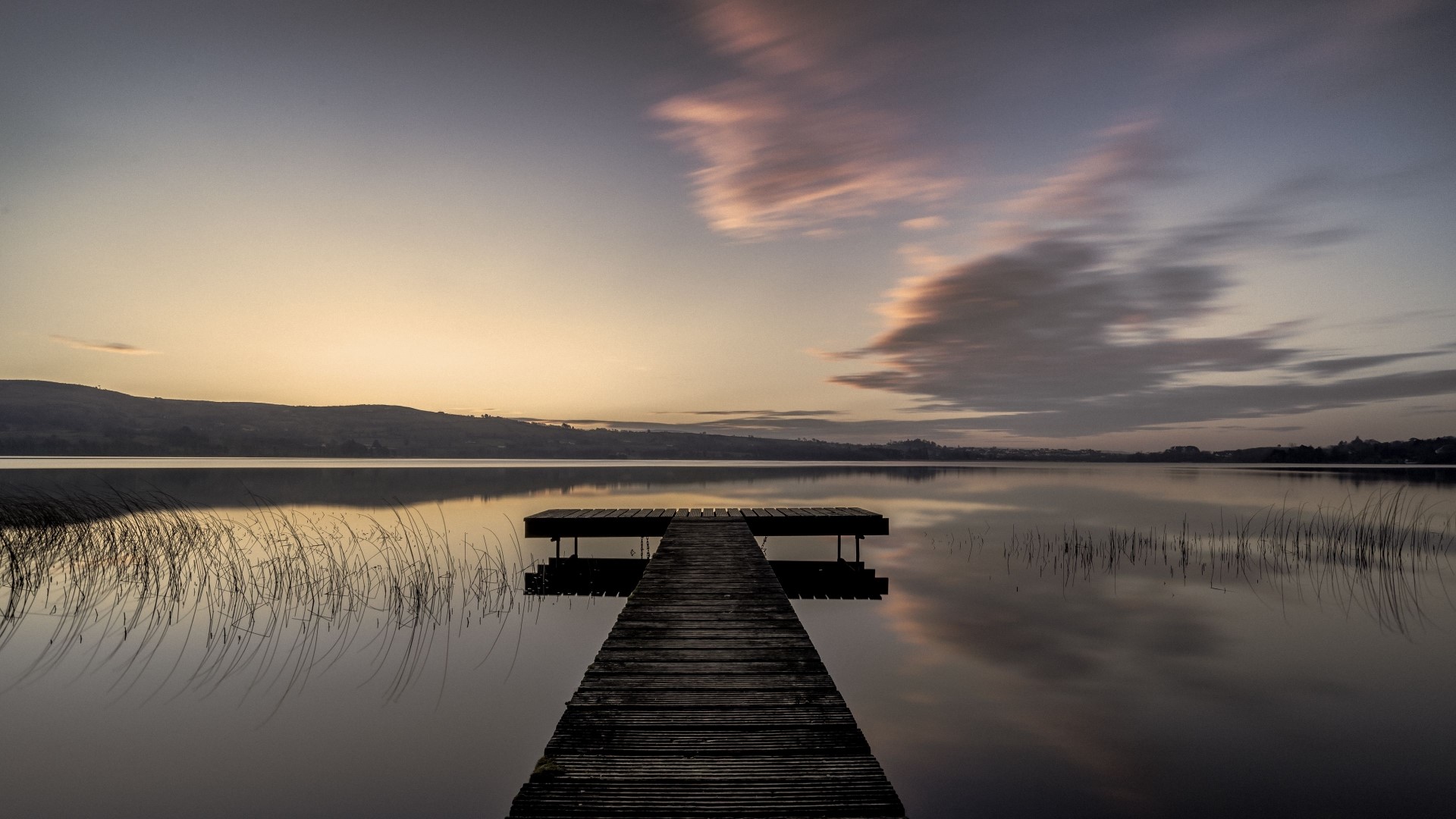 Wooden pier on a calm lake at sunrise HD Wallpaper