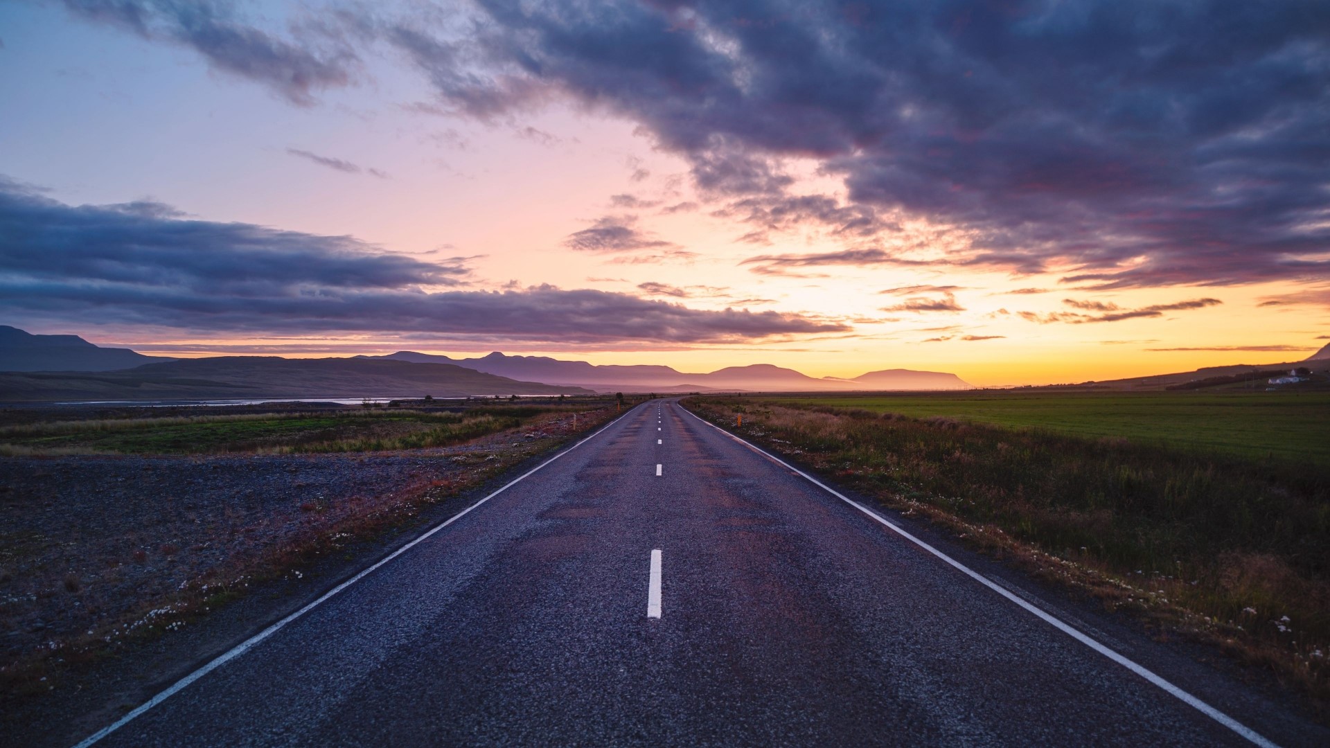 Road through a landscape at sunset HD Wallpaper