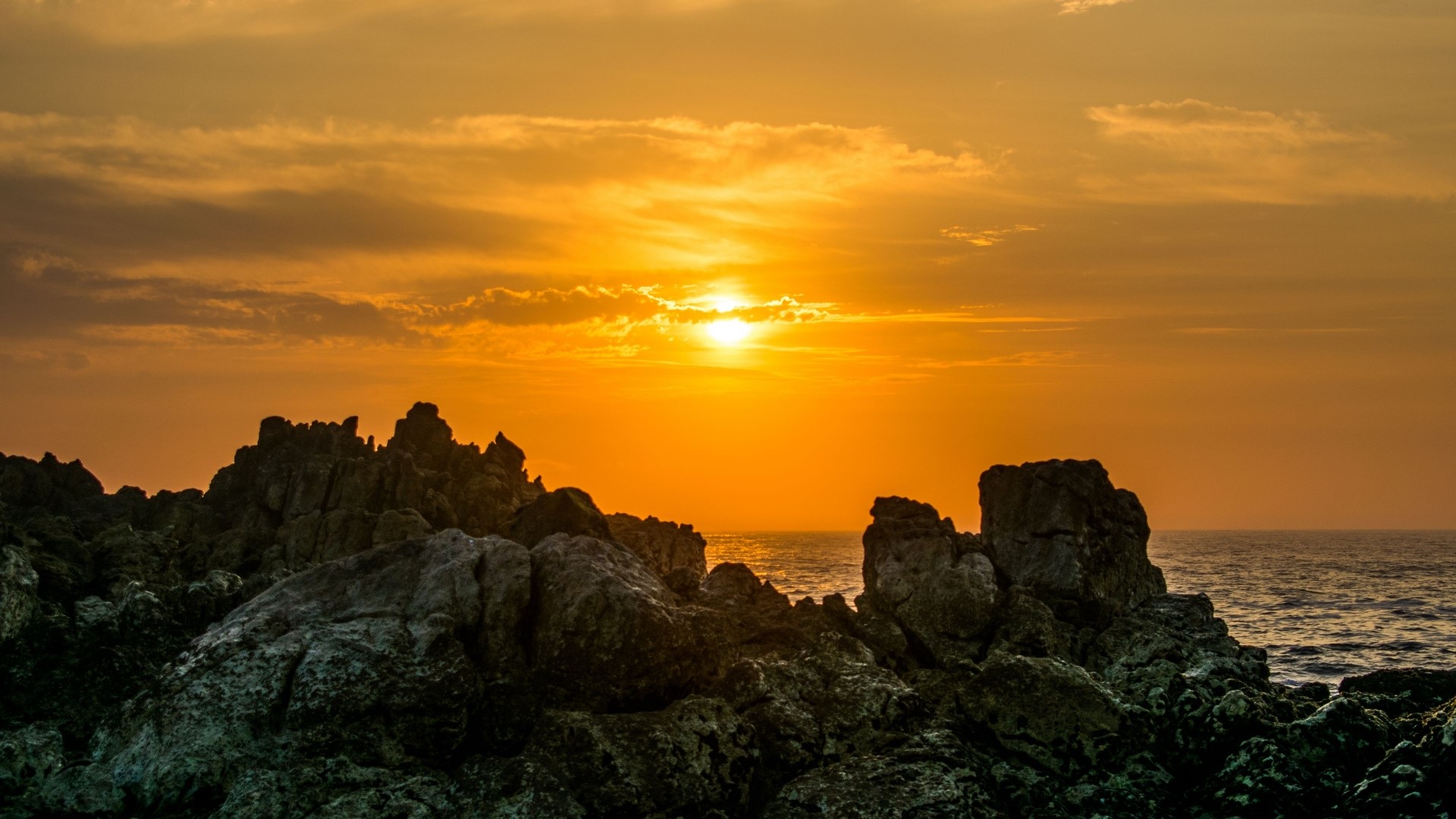 Sunset over rocky coast with ocean HD Wallpaper