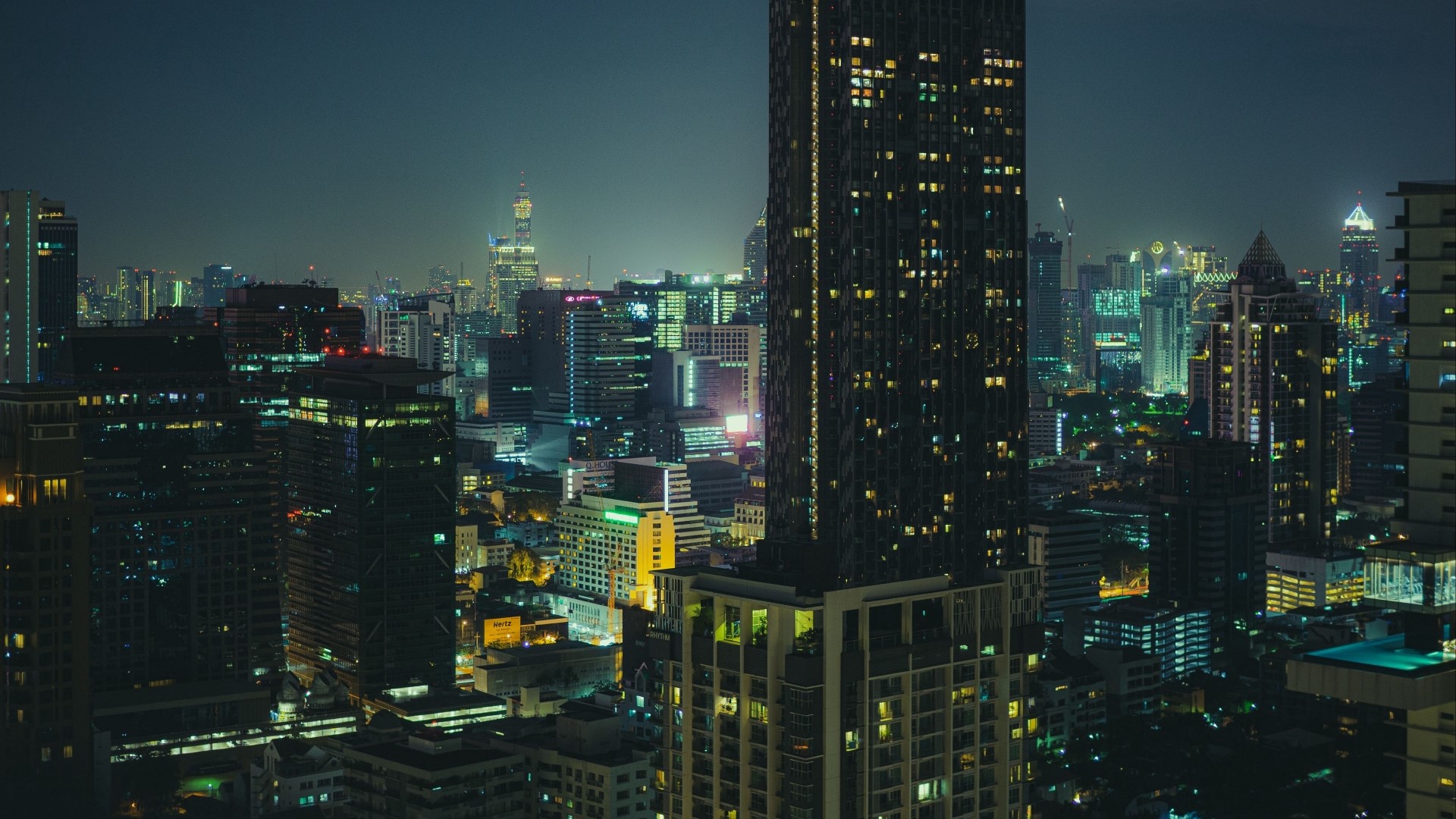 Night city skyline with illuminated skyscrapers HD Wallpaper