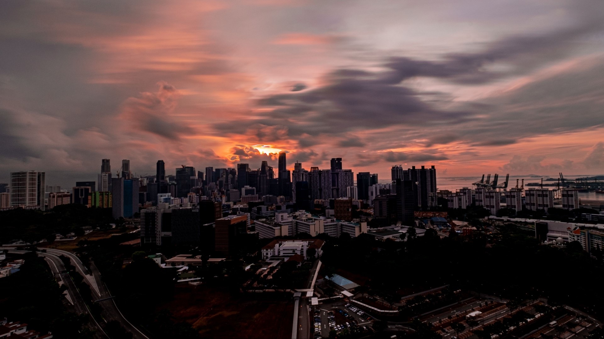 Cityscape at Sunset with Dramatic Clouds HD Wallpaper