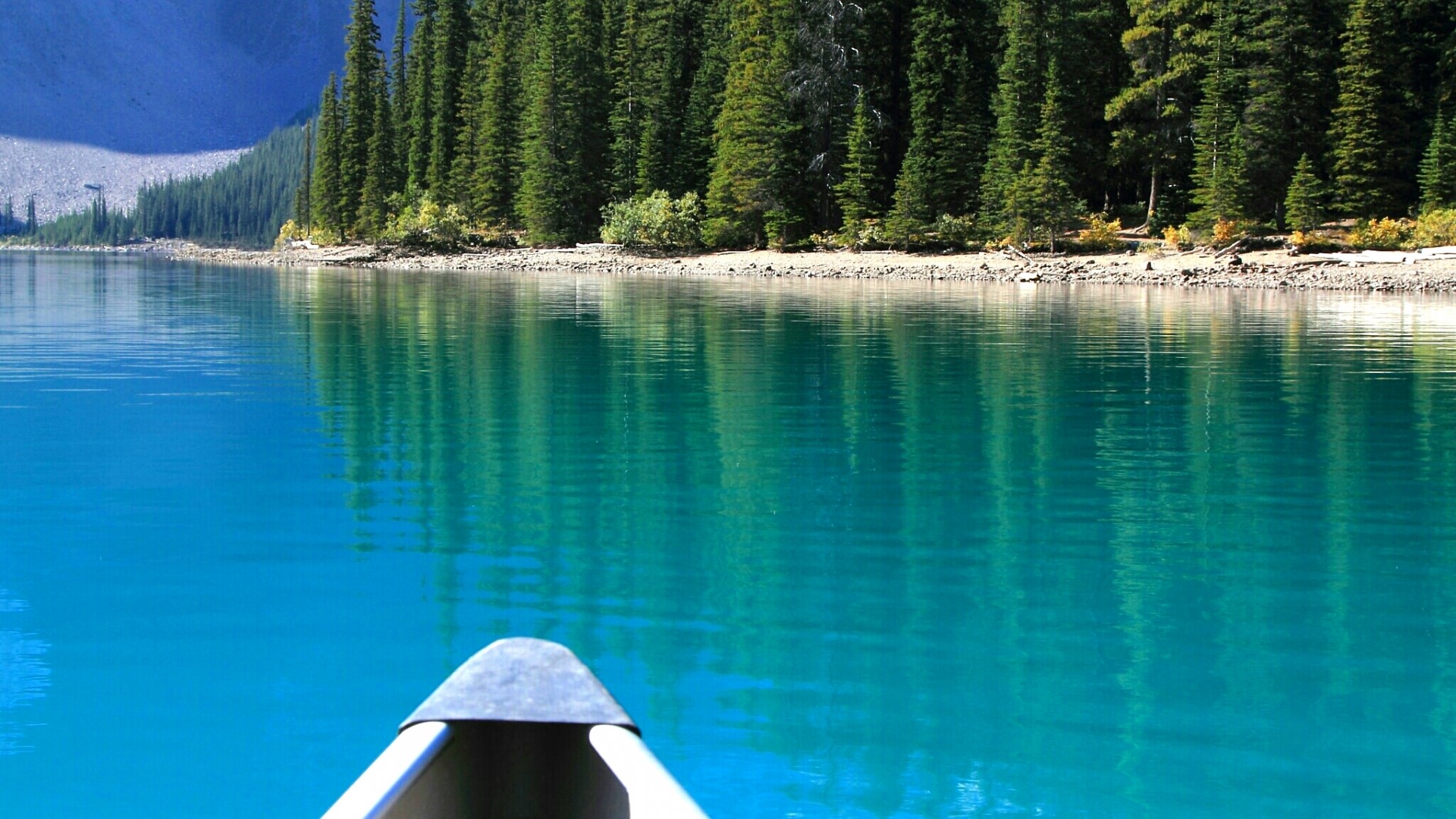 Canoe on a Turquoise Lake with Pine Forest HD Wallpaper