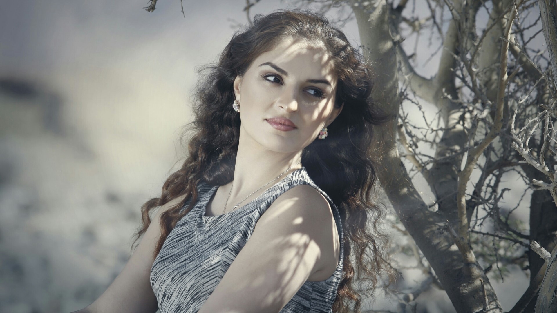 Woman with curly hair in a patterned dress HD Wallpaper