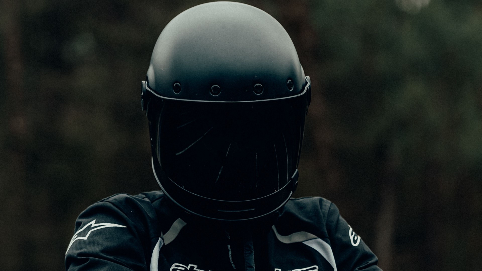 Motorcyclist wearing a black helmet and jacket HD Wallpaper
