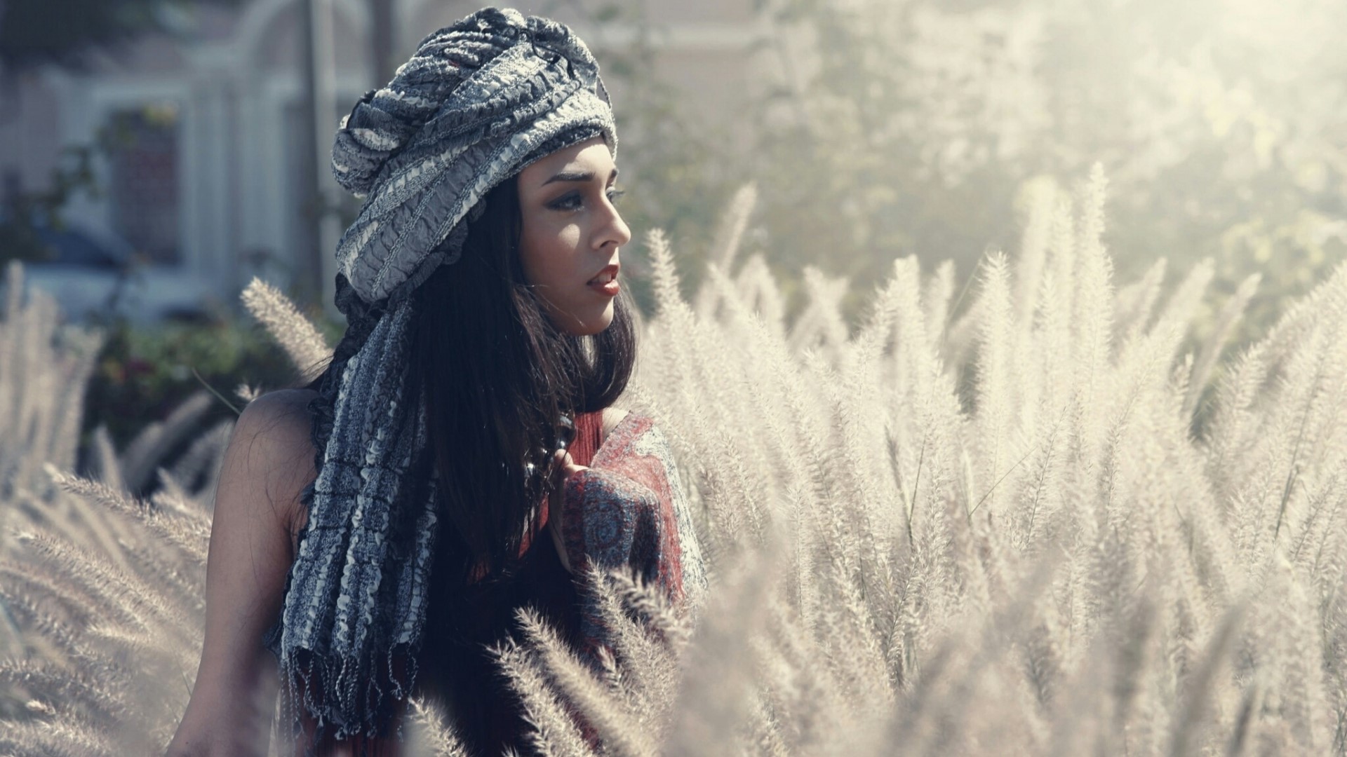 Woman wearing a headscarf in a field of tall grass HD Wallpaper