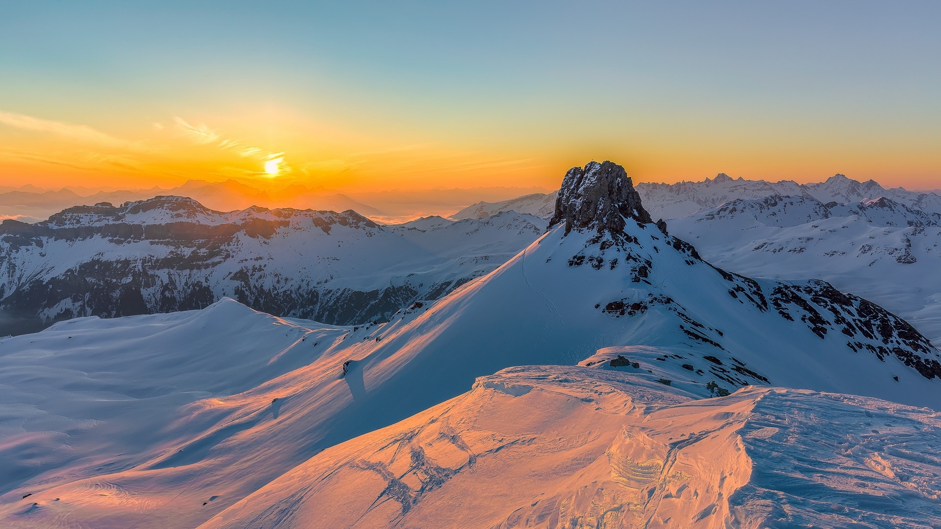 Snowy mountain peaks at sunset HD Wallpaper