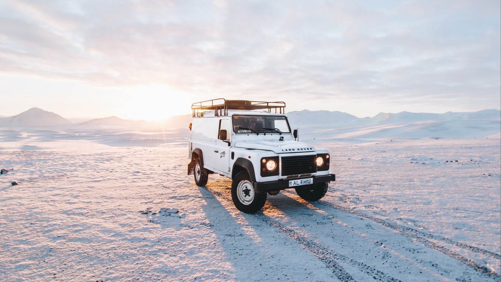 White Land Rover Defender in Snowy Landscape HD Wallpaper