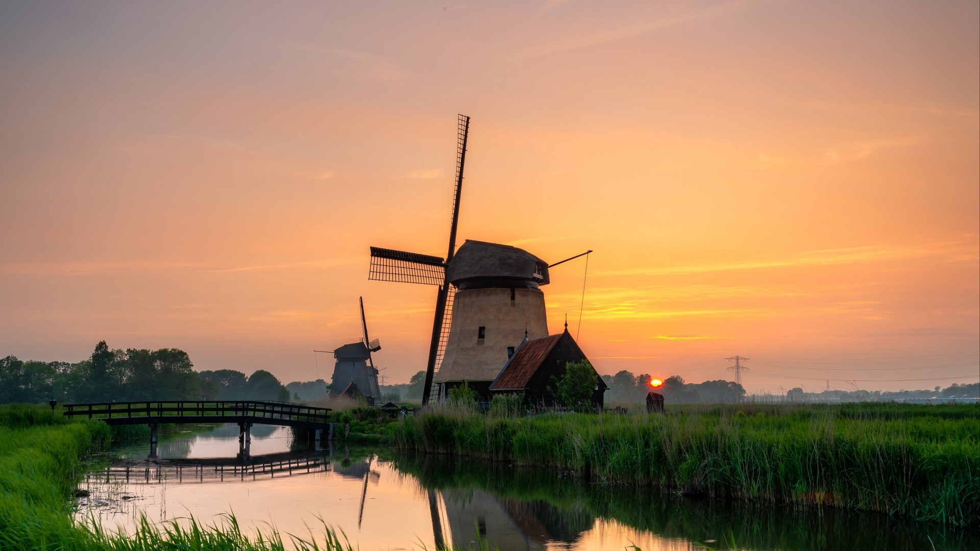 Windmills at sunset over a canal HD Wallpaper