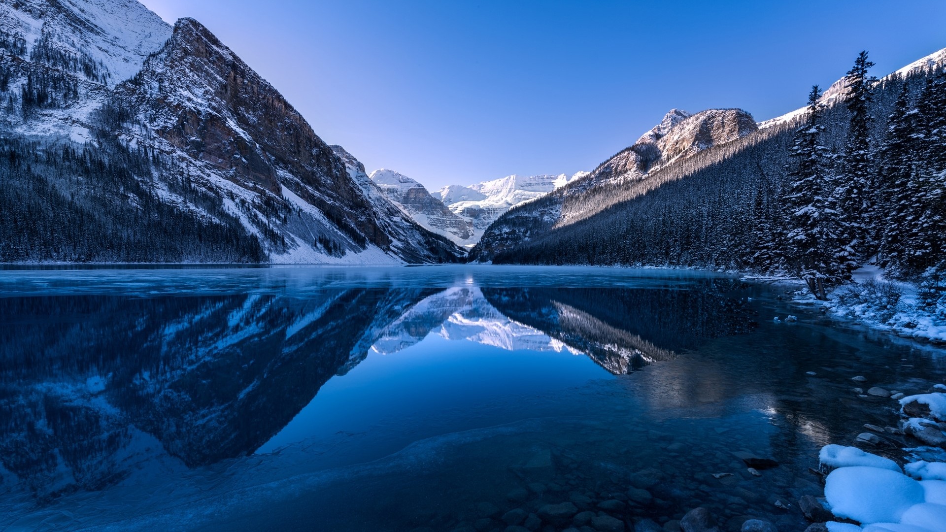 Snowy Mountains Reflecting in a Frozen Lake HD Wallpaper