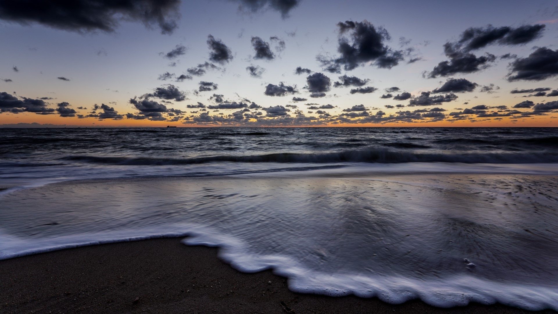 Beach at sunset with waves and clouds HD Wallpaper