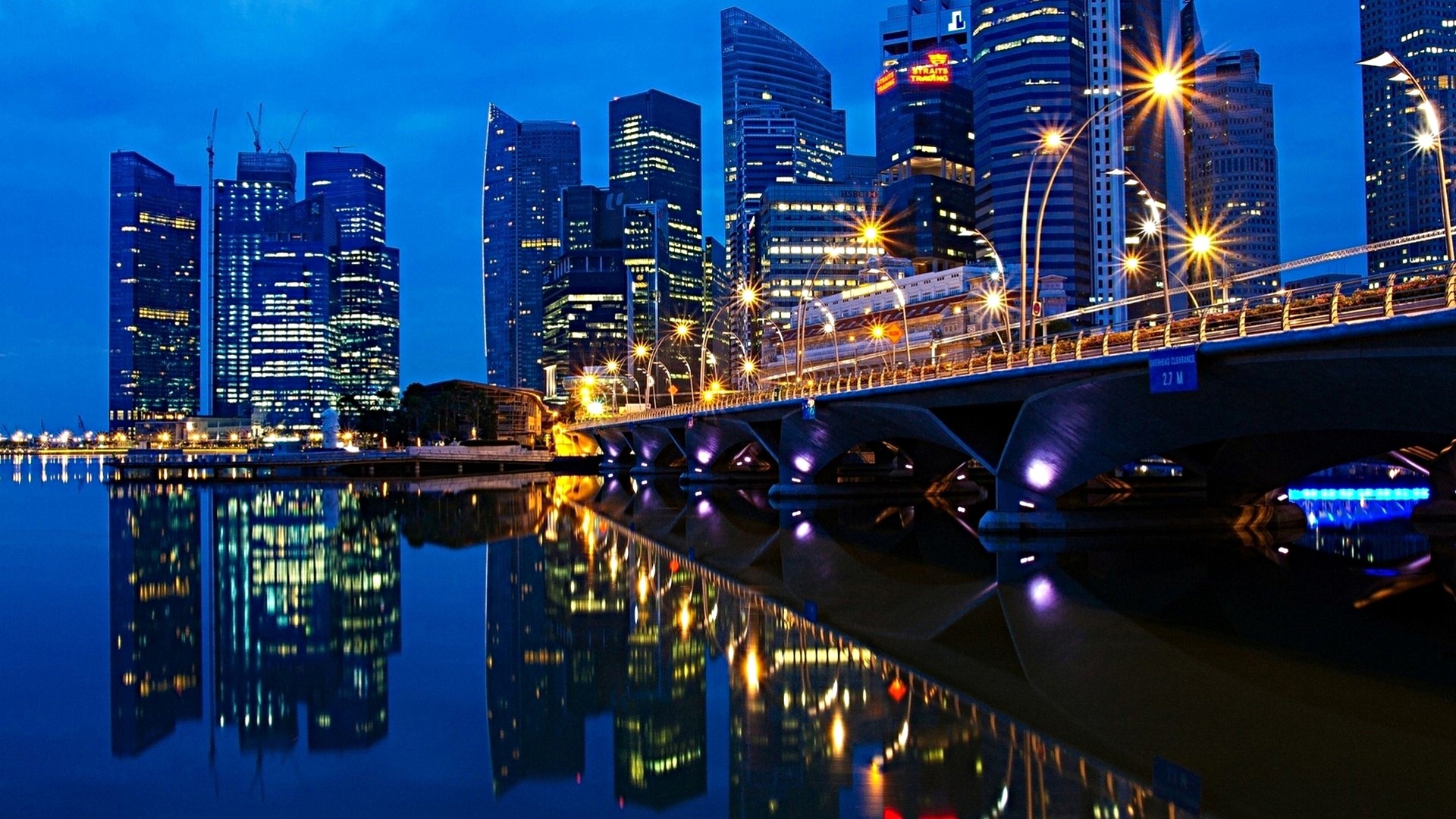 Cityscape with bridge and reflections at dusk HD Wallpaper