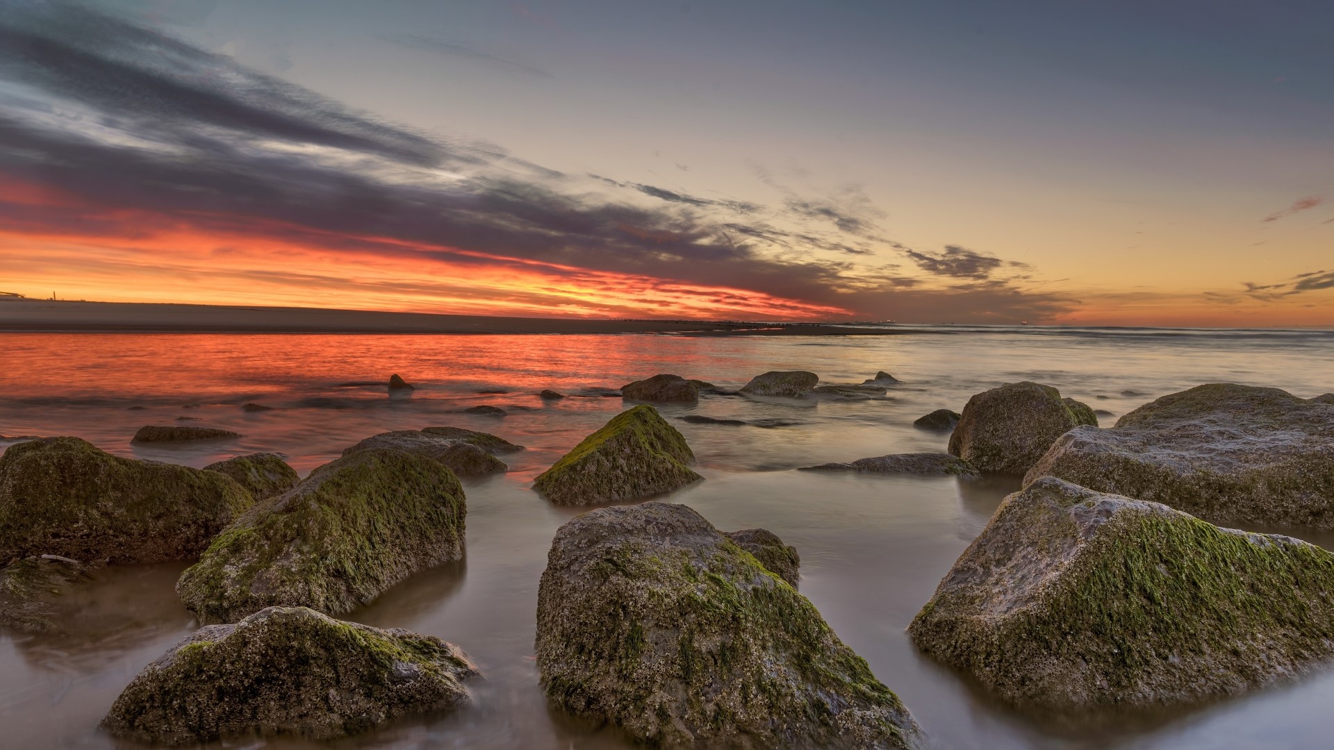 Sunset over the ocean with rocks HD Wallpaper