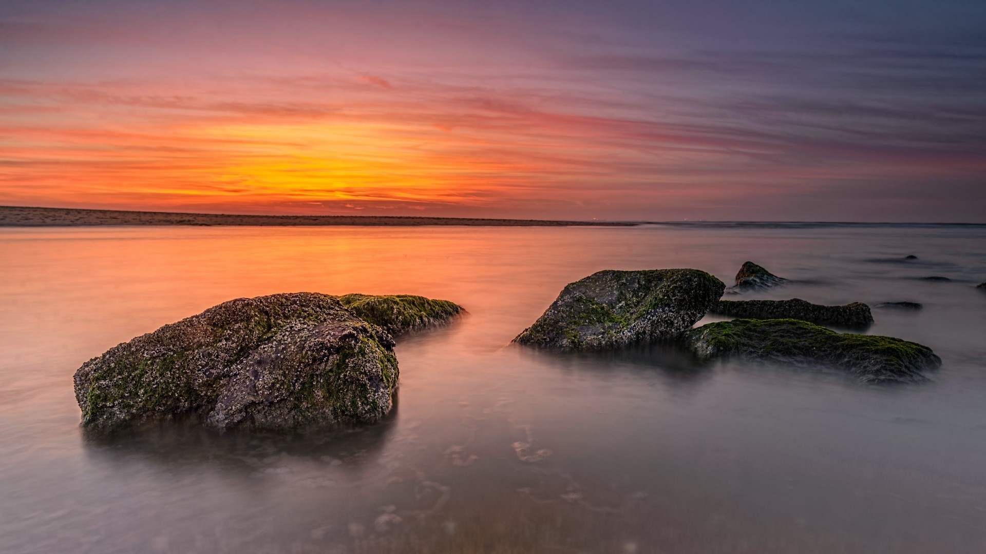 Sunset over the ocean with rocks HD Wallpaper