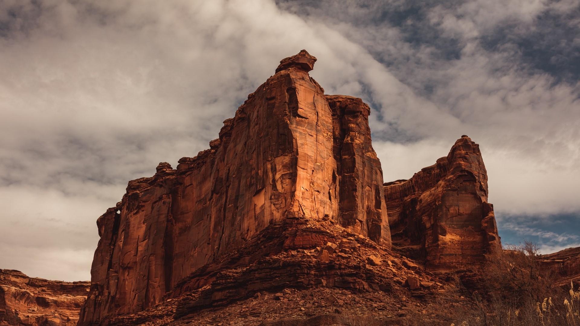 Red rock formations under a cloudy sky HD Wallpaper