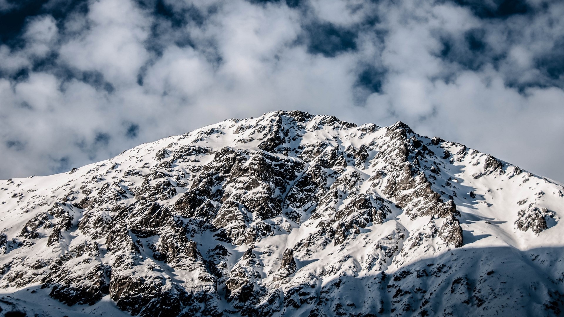 Snow-covered mountain peak with clouds HD Wallpaper