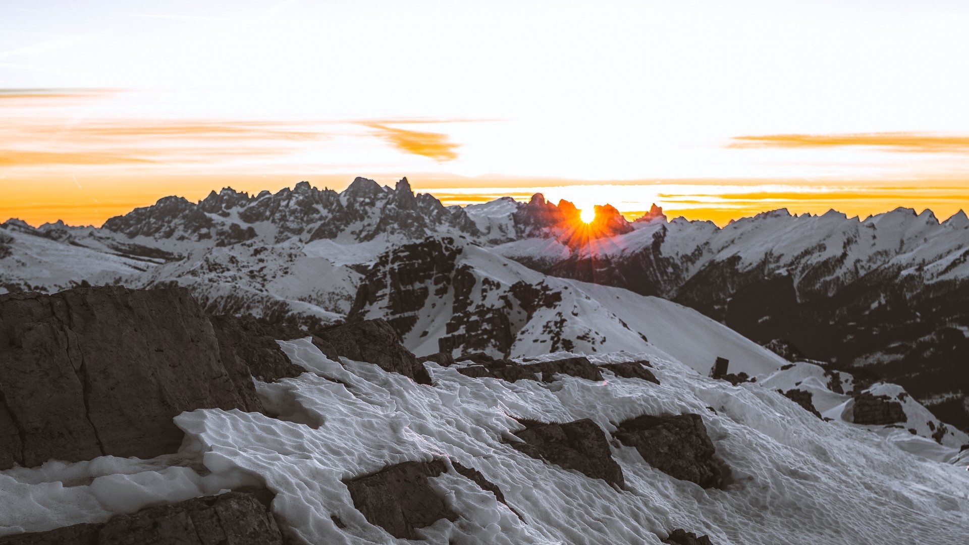 Sunset over snow-covered mountains HD Wallpaper