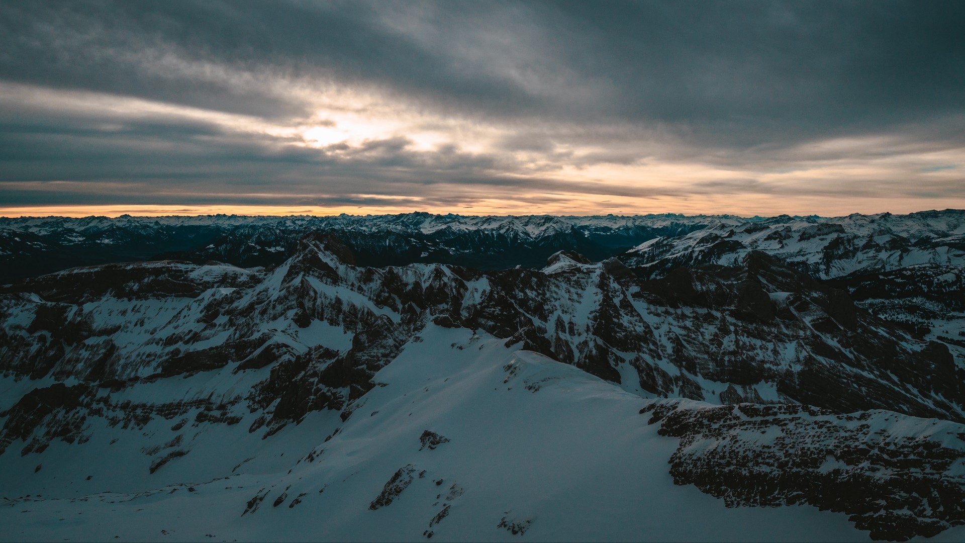 Snowy mountain range at sunset HD Wallpaper