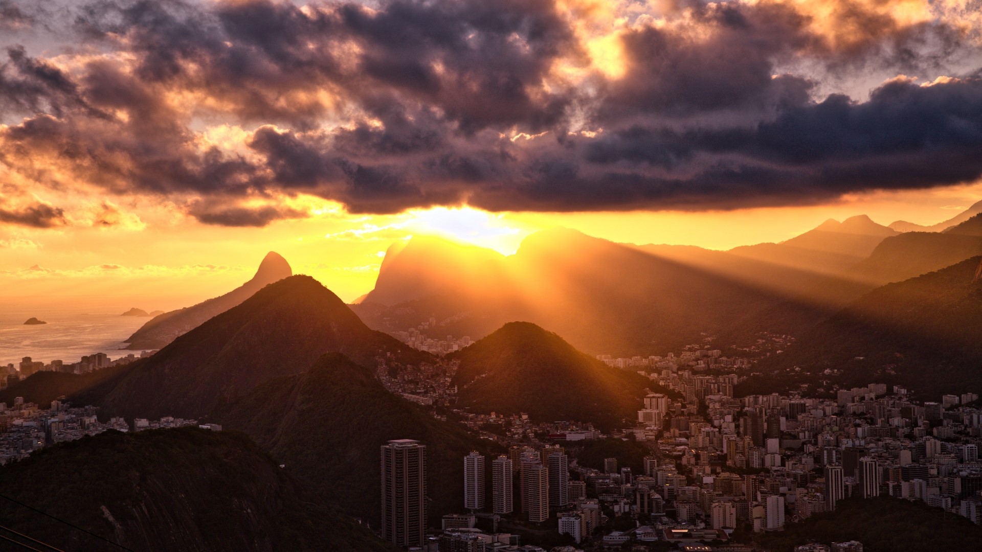 Sunset over mountains and city HD Wallpaper