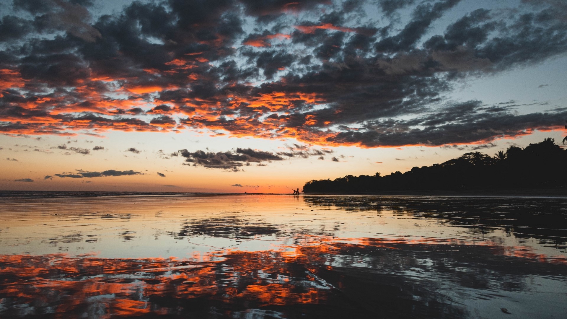 Sunset over a beach with reflections HD Wallpaper
