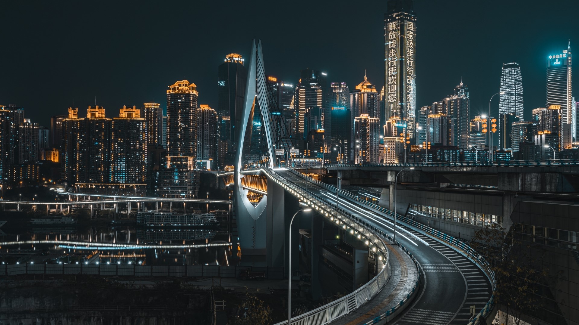 Night cityscape with illuminated bridge and skyscrapers HD Wallpaper
