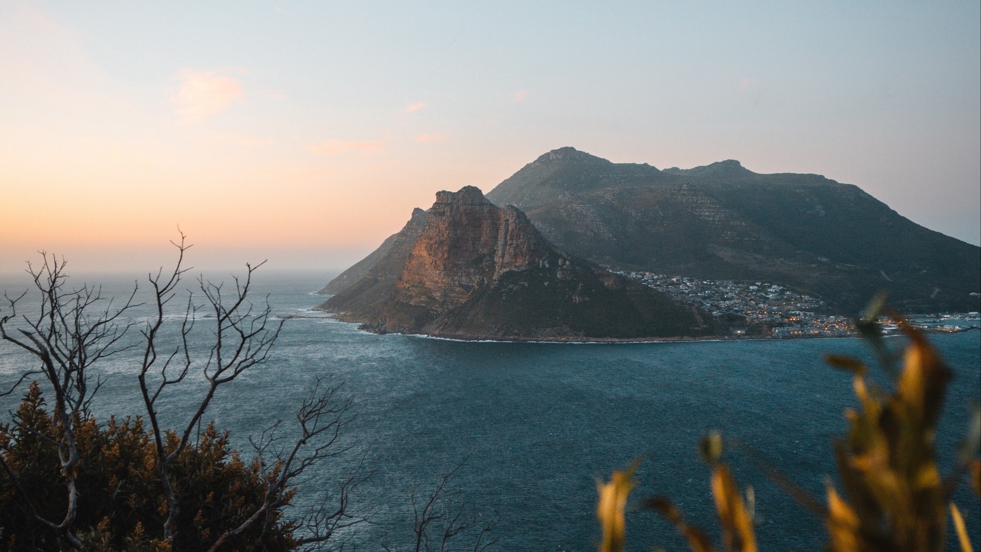 Coastal mountains and town at sunset HD Wallpaper